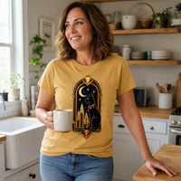 Load image into Gallery viewer, Woman in a kitchen wearing the Mustard yellow Midnight Deco Cat tee, showing the relaxed unisex fit

