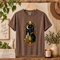 Load image into Gallery viewer, Espresso brown Midnight Deco Cat tee on a wooden hanger in a styled room with plants and a candle
