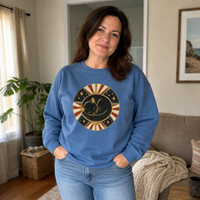 Load image into Gallery viewer, Woman at home wearing the Blue Jean Celestial Cat Nap sweatshirt, showing the relaxed unisex fit
