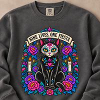 Load image into Gallery viewer, Close-up of the Nine Lives, One Fiesta sugar skull black cat design with flowers and candles on a Pepper sweatshirt
