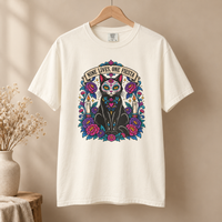 Load image into Gallery viewer, Ivory Nine Lives, One Fiesta Day of the Dead black cat graphic tee on a wooden hanger
