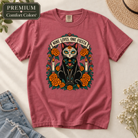Load image into Gallery viewer, Crimson Comfort Colors tee with Nine Lives, One Fiesta Día de Muertos black cat design, orange marigolds and candles
