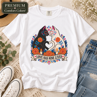 Load image into Gallery viewer, Love Has Nine Lives Brights Day of the Dead black cat t-shirt in White, Comfort Colors, flat lay with jeans and sneakers
