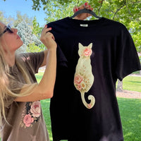 Load image into Gallery viewer, Close-up of the light floral cat silhouette design on a garment-dyed Comfort Colors tee
